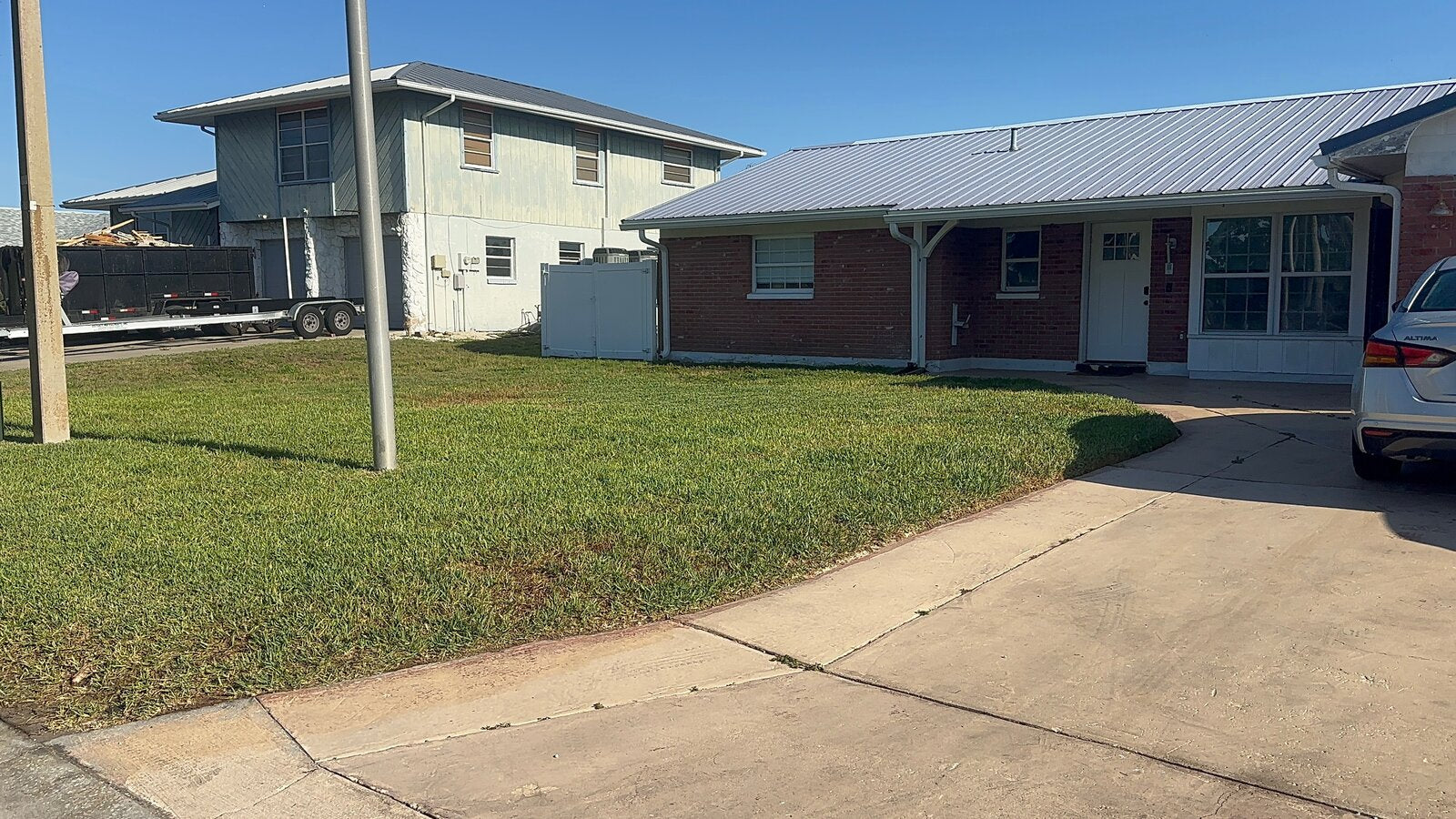 Freshly cut front lawn beside a clean driveway by TruEdge
